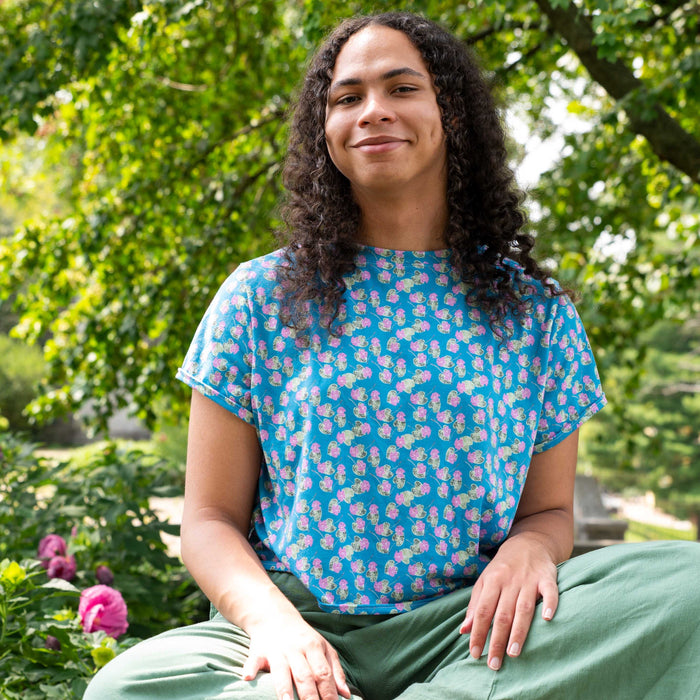 Blue espadrilles with pink flowers. 