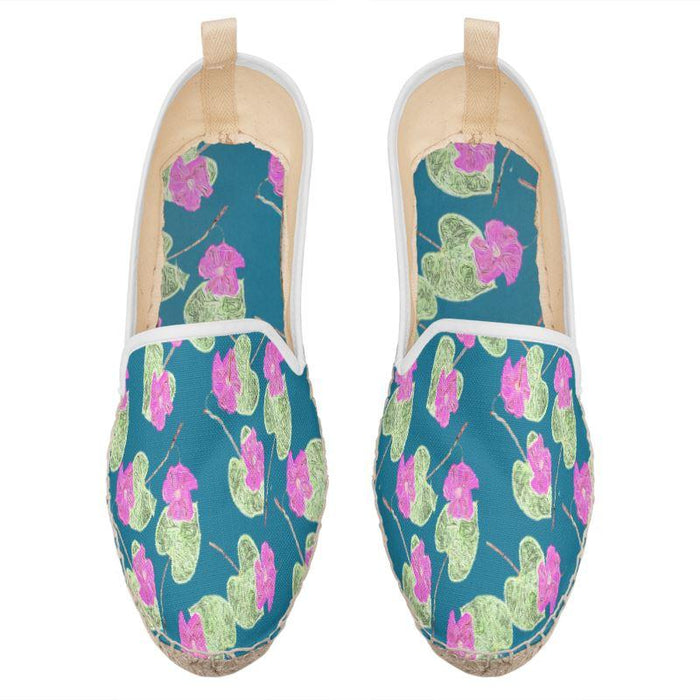 Blue espadrilles with pink flowers. 